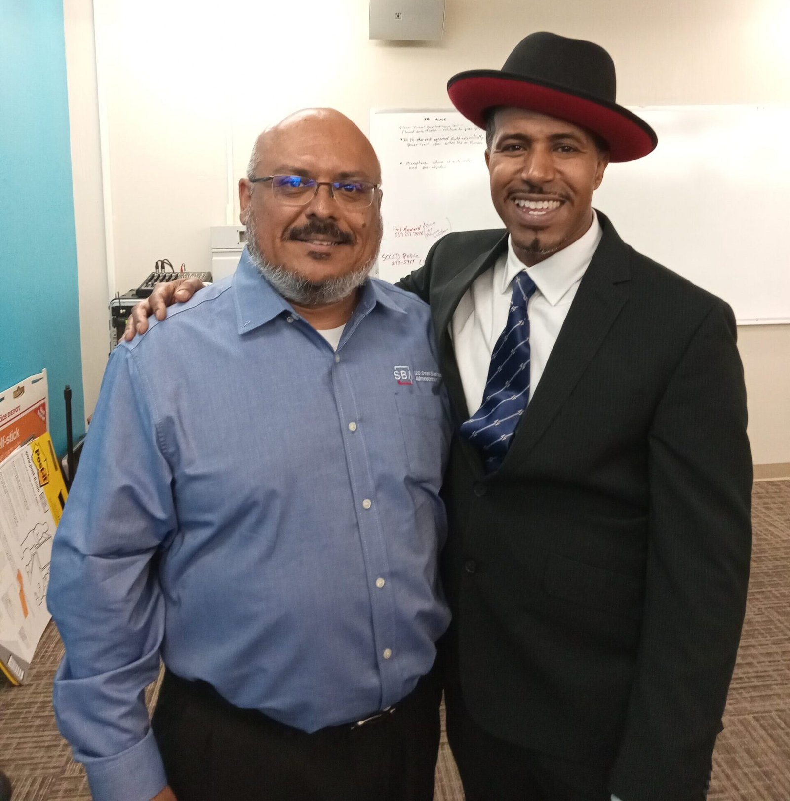 Kelly Morris, MBA of BeUncommon 24-7 with George Flores, Deputy District Director of the SBA Fresno District Office