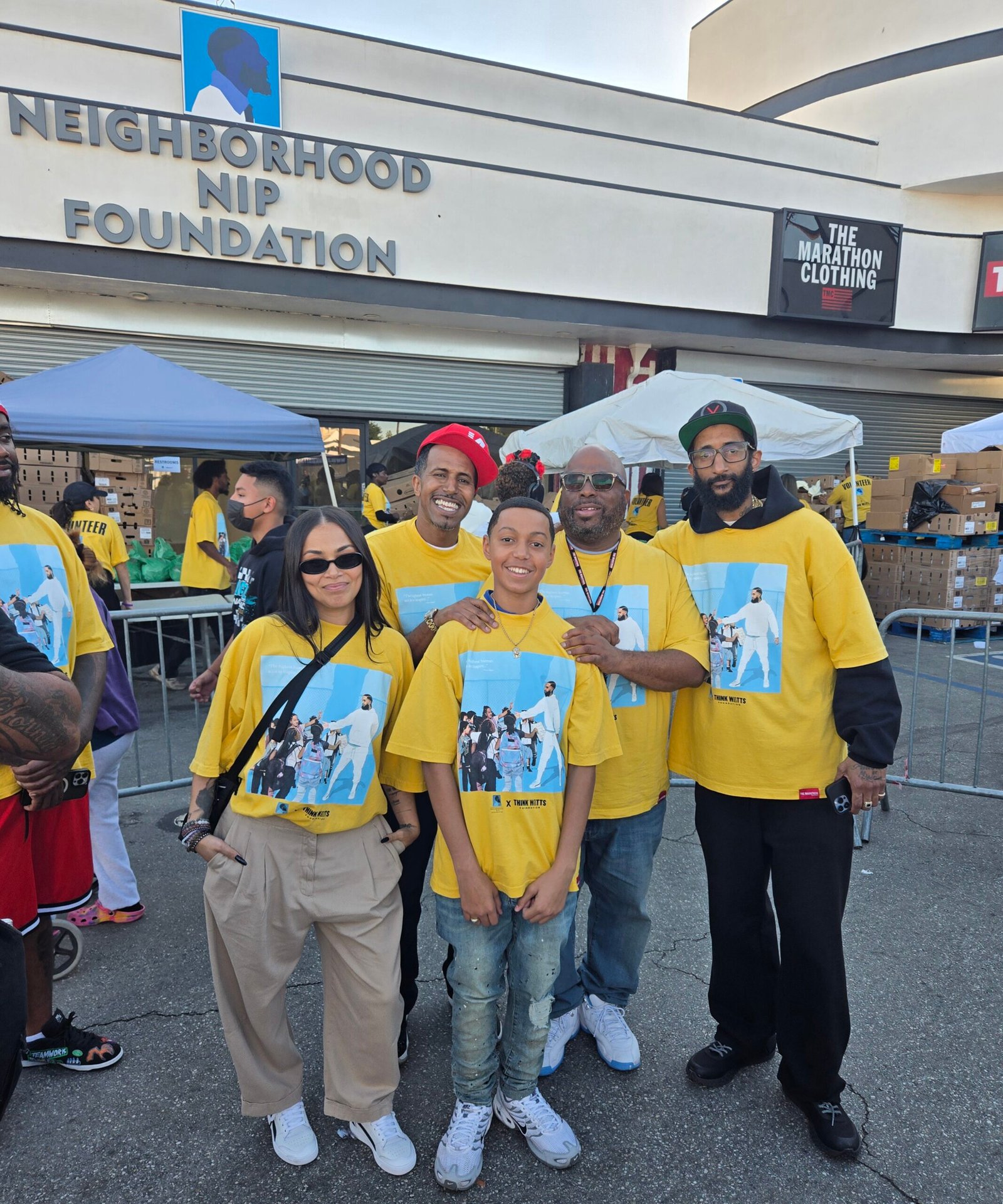 Lauren London, Kelly Morris, MBA and son, Melvin Munir, and Blacc Sam together at The Marathon Store during the Nipsey Hussle Square Turkey Drive 2025.
