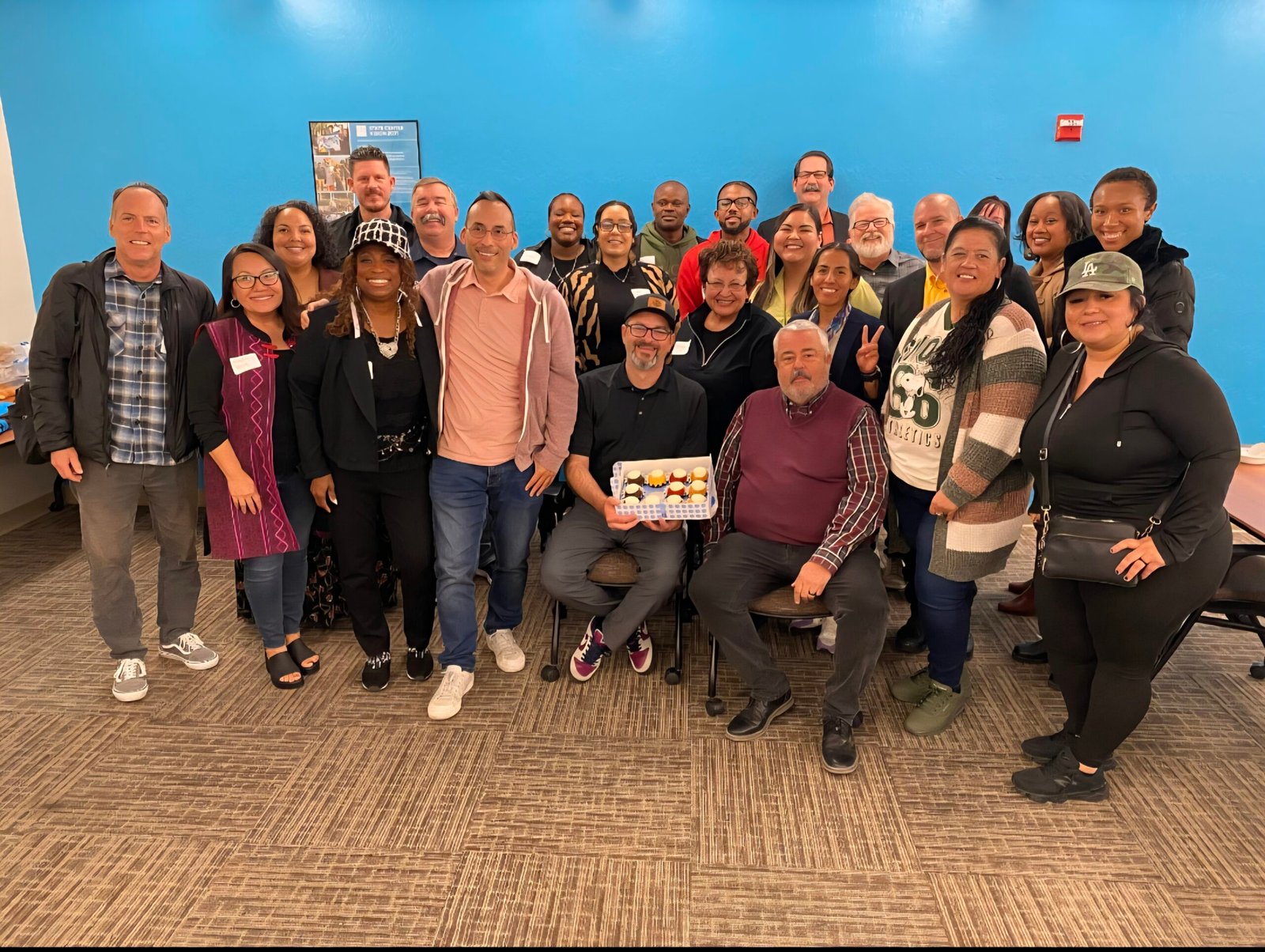 Korey Morris, CEO of BeUncommon 24-7, standing with Cheryl Flowers of FlowSynergy and fellow entrepreneurs at the BBB Growth Surge Bootcamp.